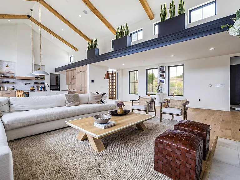 Open living area with white oak floors and dark trim ledge in a Corrales, NM custom home by Infinity Builders
