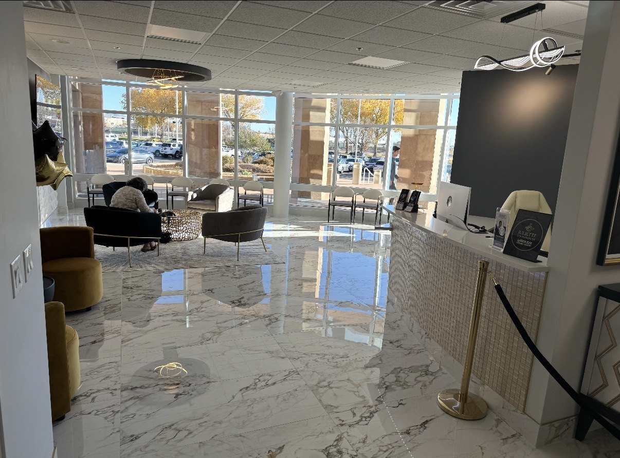 Eye doctor’s office waiting room with marble floors and floor-to-ceiling windows, built by Infinity Builders in New Mexico