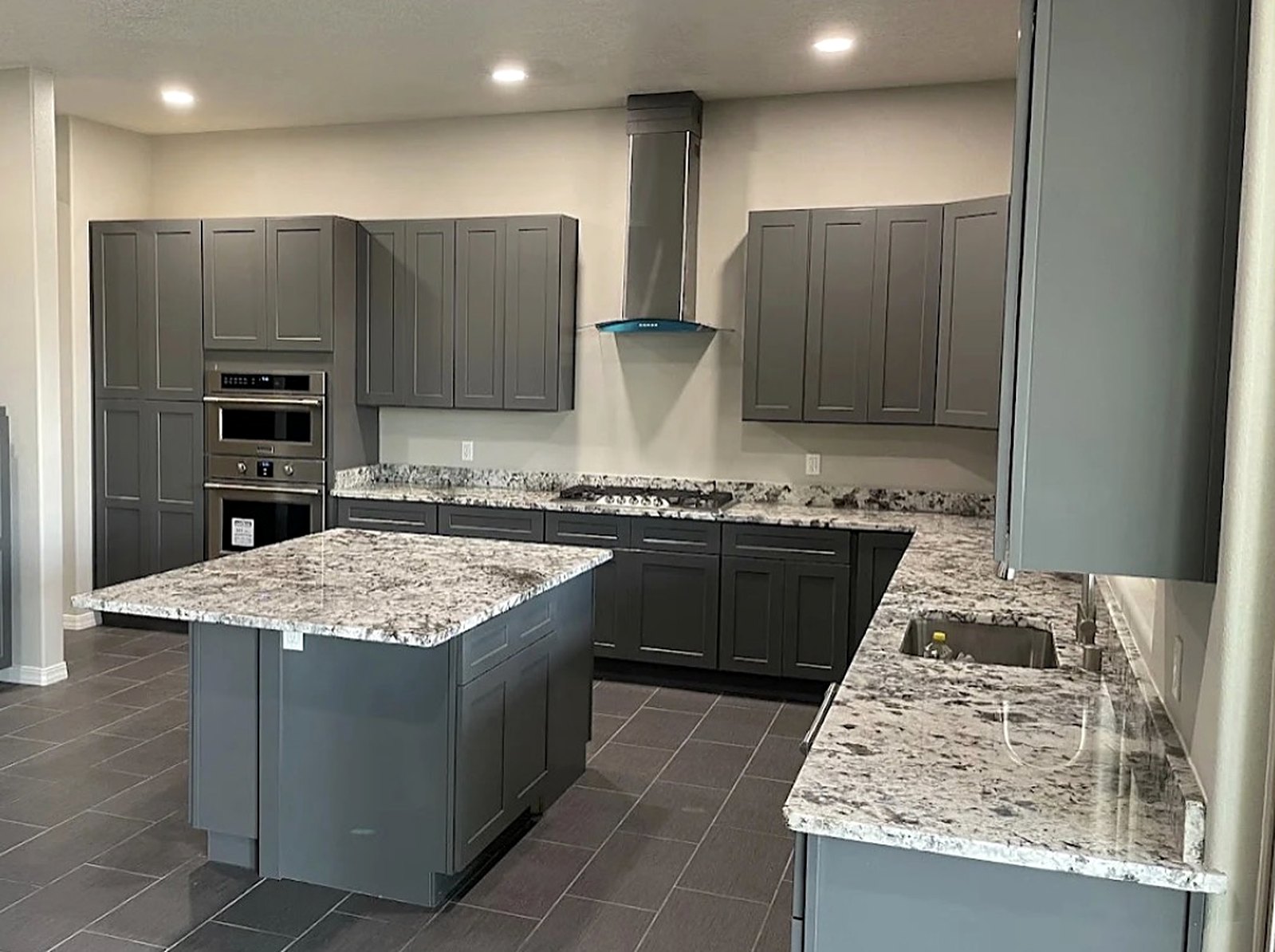 Gray shaker kitchen with granite island