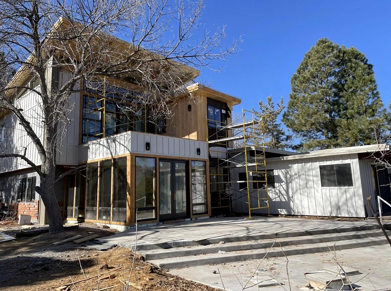 Two-story exterior renovation with patio