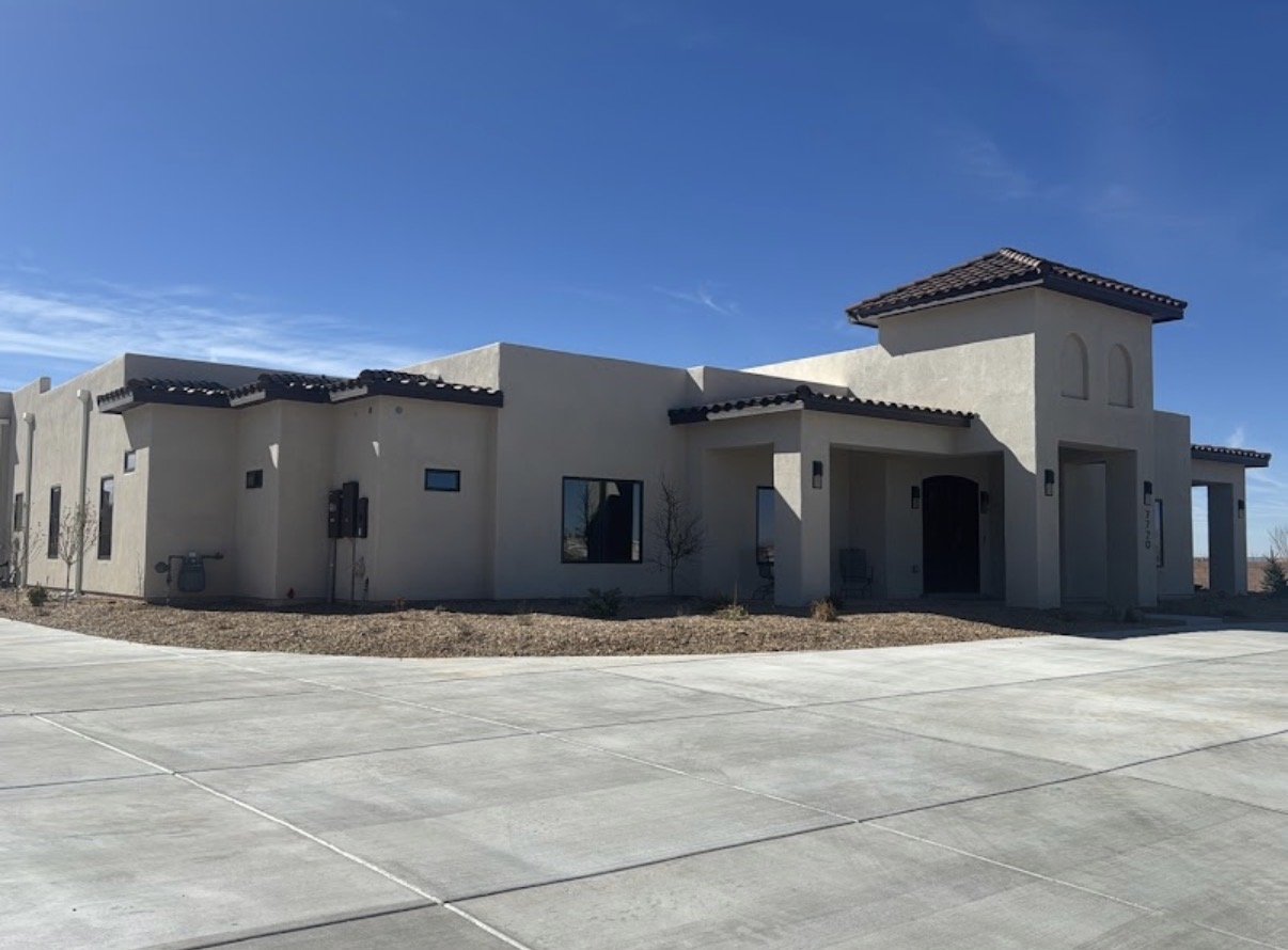 Territorial-style custom estate with tiled tower entry